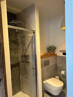 a bathroom with a shower and a toilet at Hello Noordwijk - Studio Pietheinplein 1 in Noordwijk aan Zee