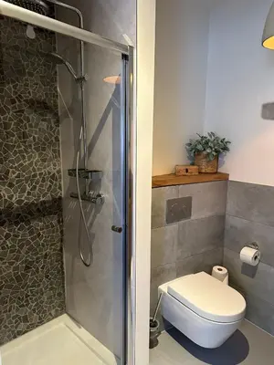 a bathroom with a shower with a toilet and a sink at Hello Noordwijk - Studio Pietheinplein 1 in Noordwijk aan Zee