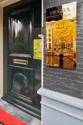a window of a store with a picture of a building at Stanley Collection Hotel Hegra Amsterdam in Amsterdam