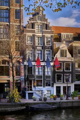 a group of buildings next to a river at Stanley Collection Hotel Hegra Amsterdam in Amsterdam
