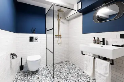 a bathroom with blue walls and a sink and a toilet at Stanley Collection Hotel Hegra Amsterdam in Amsterdam