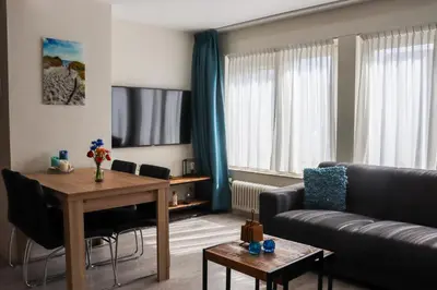 a living room with a couch and a table at Zeezand in Egmond aan Zee