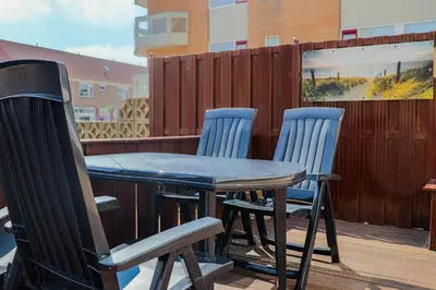 a table and chairs sitting on a patio at Zeezand in Egmond aan Zee