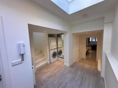 a laundry room with a washer and dryer in a house at Tulip House Luxury Apartment - Top Location - Rijksmuseum - Leidseplein AMSTERDAM Central 120 m2 ALL Private with kitchen in Amsterdam
