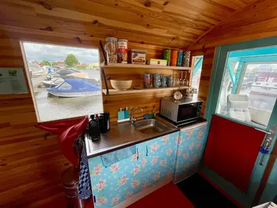 a small kitchen with a sink and a microwave at Island Sleeping in Aalsmeer