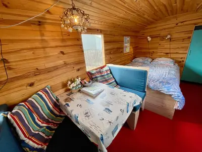 a bedroom with a bed and a table in a room at Island Sleeping in Aalsmeer