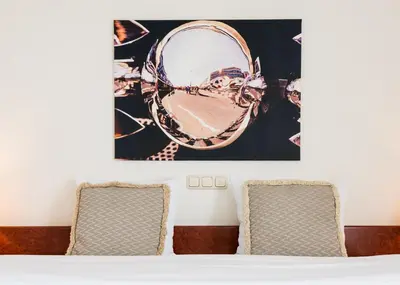 a room with two chairs and a mirror on the wall at Prominent Inn Hotel in Noordwijk aan Zee