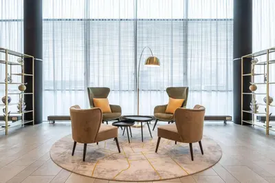 a living room with chairs and a table and a rug at Park Plaza Amsterdam Airport in Lijnden