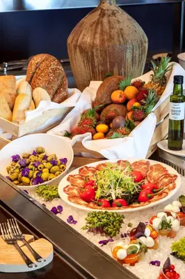 a buffet with many different types of food and bread at Park Plaza Amsterdam Airport in Lijnden