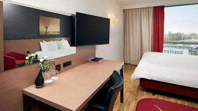 a hotel room with a desk and a bed at Park Plaza Amsterdam Airport in Lijnden