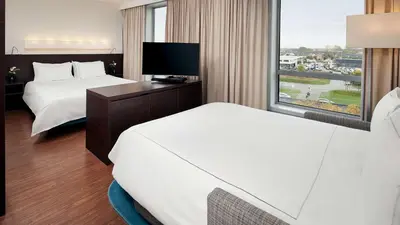 a hotel room with two beds and a window at Park Plaza Amsterdam Airport in Lijnden
