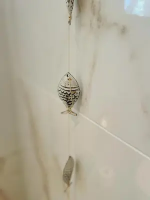 a bird ornament hanging on a wall at Villa de Duinfazant in Bergen aan Zee