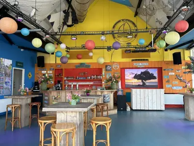 a restaurant with tables and stools and a bar at Apartment Westergeest-1 by Interhome in Uitgeest