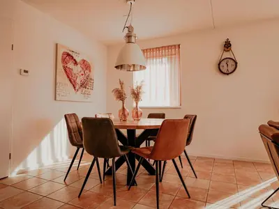 a dining room with a table and chairs at Apartment Westergeest-1 by Interhome in Uitgeest