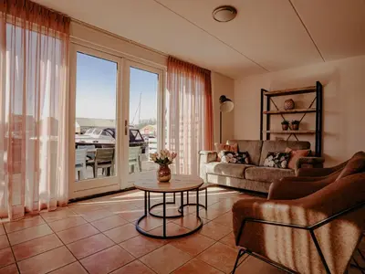 a living room with a couch and a table at Apartment Westergeest-1 by Interhome in Uitgeest