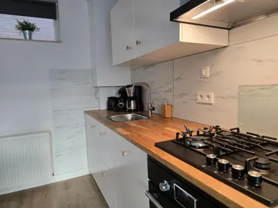 a kitchen with a stove and a sink at Moana 1 in Egmond aan Zee