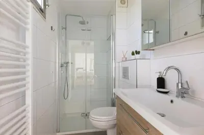 a bathroom with a shower and a toilet and a sink at New- Private Cosy Houseboat, on a lake near Amsterdam in Vinkeveen