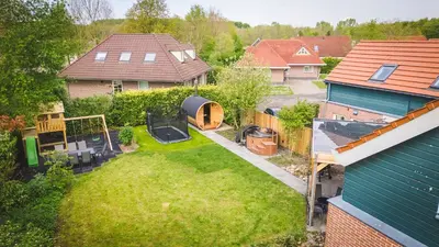 an aerial view of a backyard of a house at Newly renovated luxurious Villa / hottub / sauna / 7 bedrooms in Zeewolde