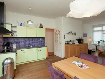 a kitchen and dining room with a table and a kitchen and a room at Holiday Home in Alkmaar by Canal in Alkmaar
