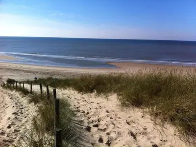a sandy beach with the ocean in the background at Holiday Home in Alkmaar by Canal in Alkmaar
