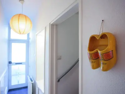 a pair of shoes hanging on a wall next to a door at Holiday Home in Alkmaar by Canal in Alkmaar
