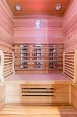 a sauna with two chairs in a wooden room at Hello Noordwijk - Wellness Huis Schoolstraat 47B in Noordwijk aan Zee