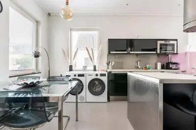 a kitchen with a washing machine and a dishwasher at Hello Noordwijk - Wellness Huis Schoolstraat 47B in Noordwijk aan Zee