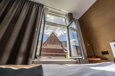 a view of a church from a bedroom window at Hotel Montfoort in Montfoort