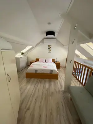 a bedroom with a bed in the middle of a room at Appartement Lijnden in Lijnden