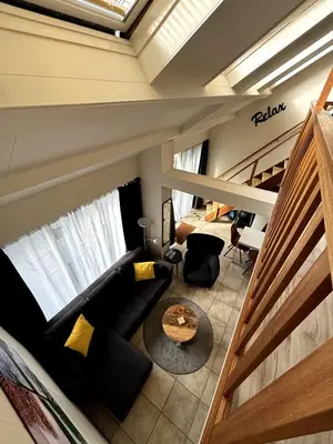 a living room with a couch and a table at Appartement Lijnden in Lijnden