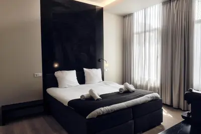 a bedroom with a bed with two teddy bears on it at AmsterHome Hotel in Amsterdam