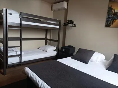 a bedroom with two bunk beds and a ladder at AmsterHome Hotel in Amsterdam