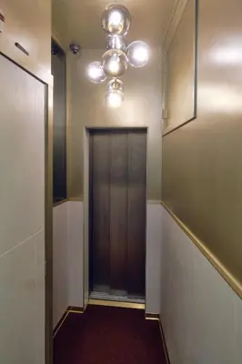 a hallway with a elevator and a ceiling at AmsterHome Hotel in Amsterdam