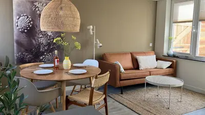 a living room with a table and a couch at Bundi Beach in Egmond aan Zee