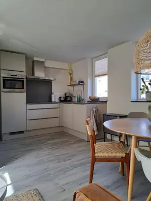 a kitchen with a table and a dining room at Bundi Beach in Egmond aan Zee