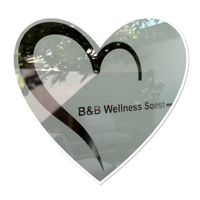 a glass heart with the words bbc wellnessost at B&B Wellness Soest in Soest