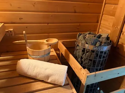 a sauna with a towel and a wooden box at B&B Wellness Soest in Soest