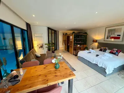 a bedroom with a bed and a table in a room at B&B Wellness Soest in Soest