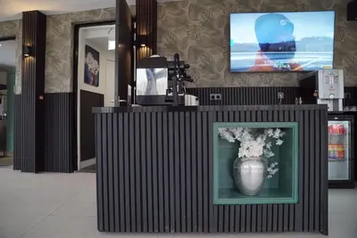 a display case with a vase with flowers in it at MA Airport Hotel in Hoofddorp