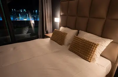 a bed with two pillows in a room with a window at MA Airport Hotel in Hoofddorp