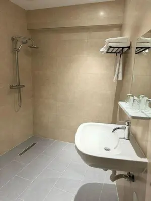 a bathroom with a sink and a shower at MA Airport Hotel in Hoofddorp