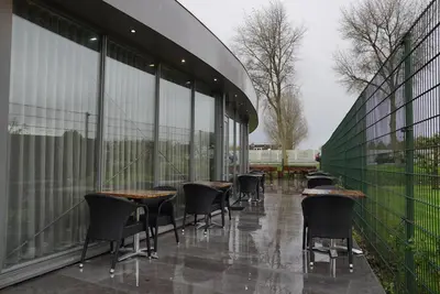 a row of tables and chairs outside of a building at MA Airport Hotel in Hoofddorp
