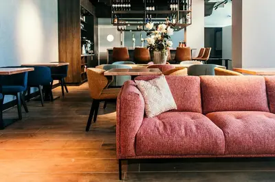a living room with a couch and a table at Amsterdam Beach Hotel in Zandvoort