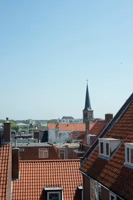a view of a city with roofs and a church at Amsterdam Beach Hotel in Zandvoort