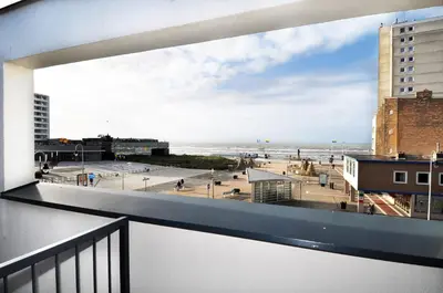 a balcony with a view of the beach and buildings at Amsterdam Beach Hotel in Zandvoort