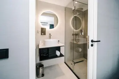 a bathroom with a sink and a shower at Amsterdam Beach Hotel in Zandvoort