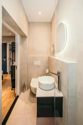 a bathroom with a white sink and a mirror at Amsterdam Beach Hotel in Zandvoort