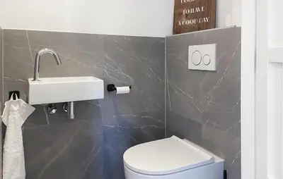 a bathroom with a white toilet and a sink at Braassermerhuis in Rijnsaterwoude