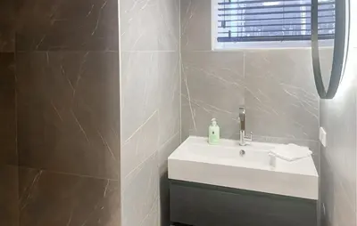 a bathroom with a white sink and a window at Braassermerhuis in Rijnsaterwoude