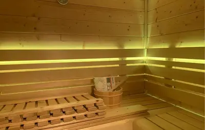a corner of a sauna with a trash can and lights at Braassermerhuis in Rijnsaterwoude